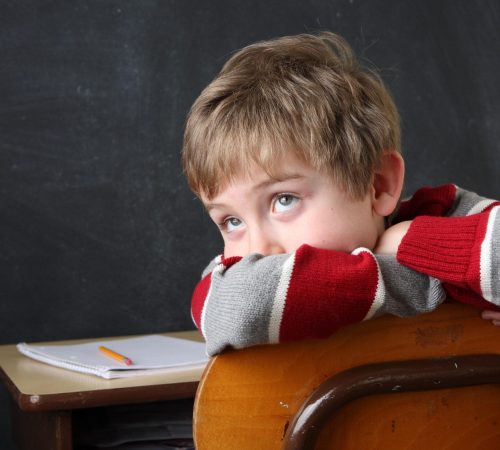 Student,Resting,His,Head,On,His,Arms,While,Looking,Up