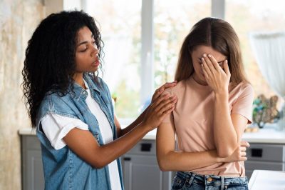 woman-consoling-her-worried-friend-kitchen_23-2148708950